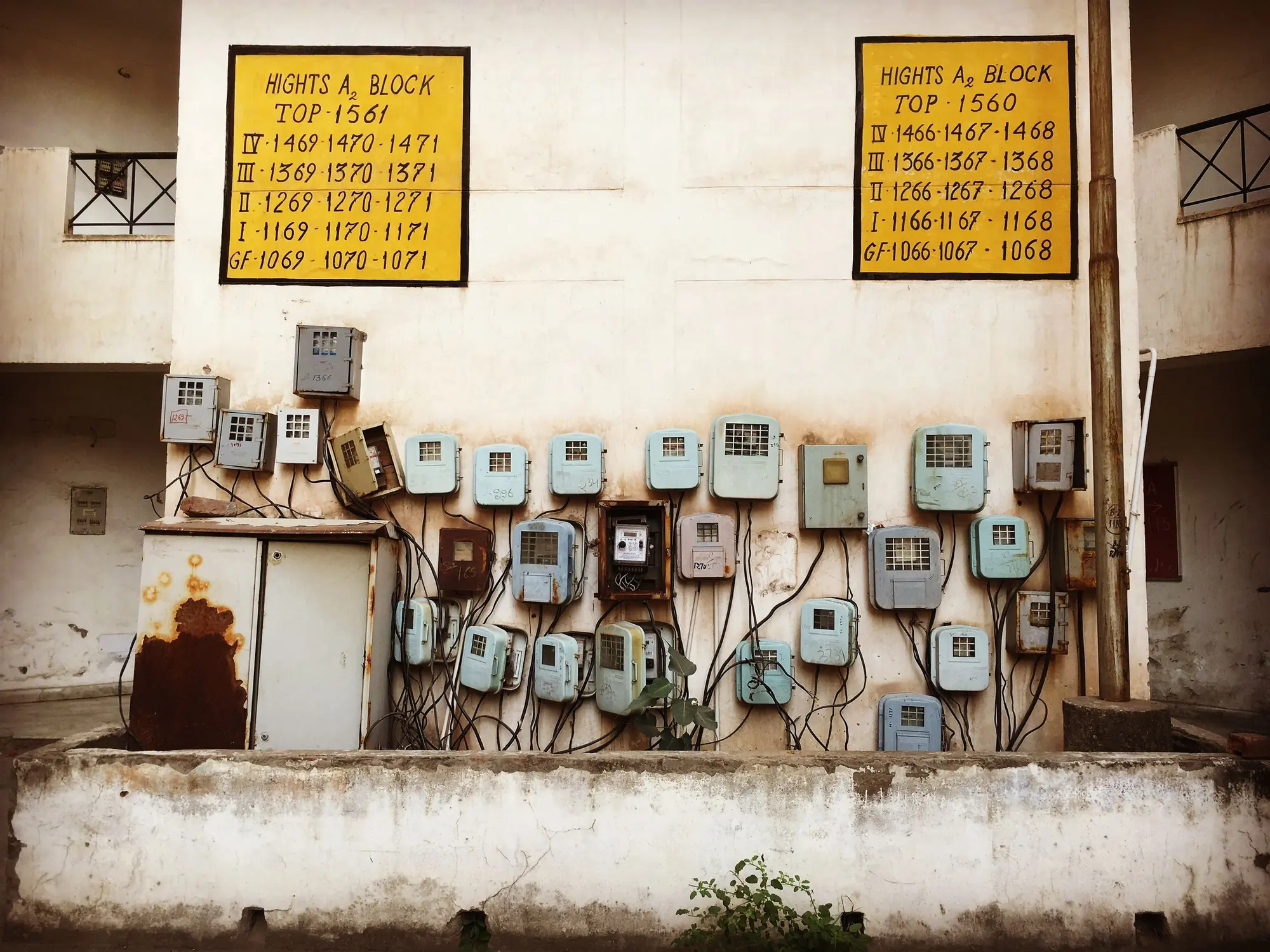 Rows of household electricity meters on the wall of a housing block